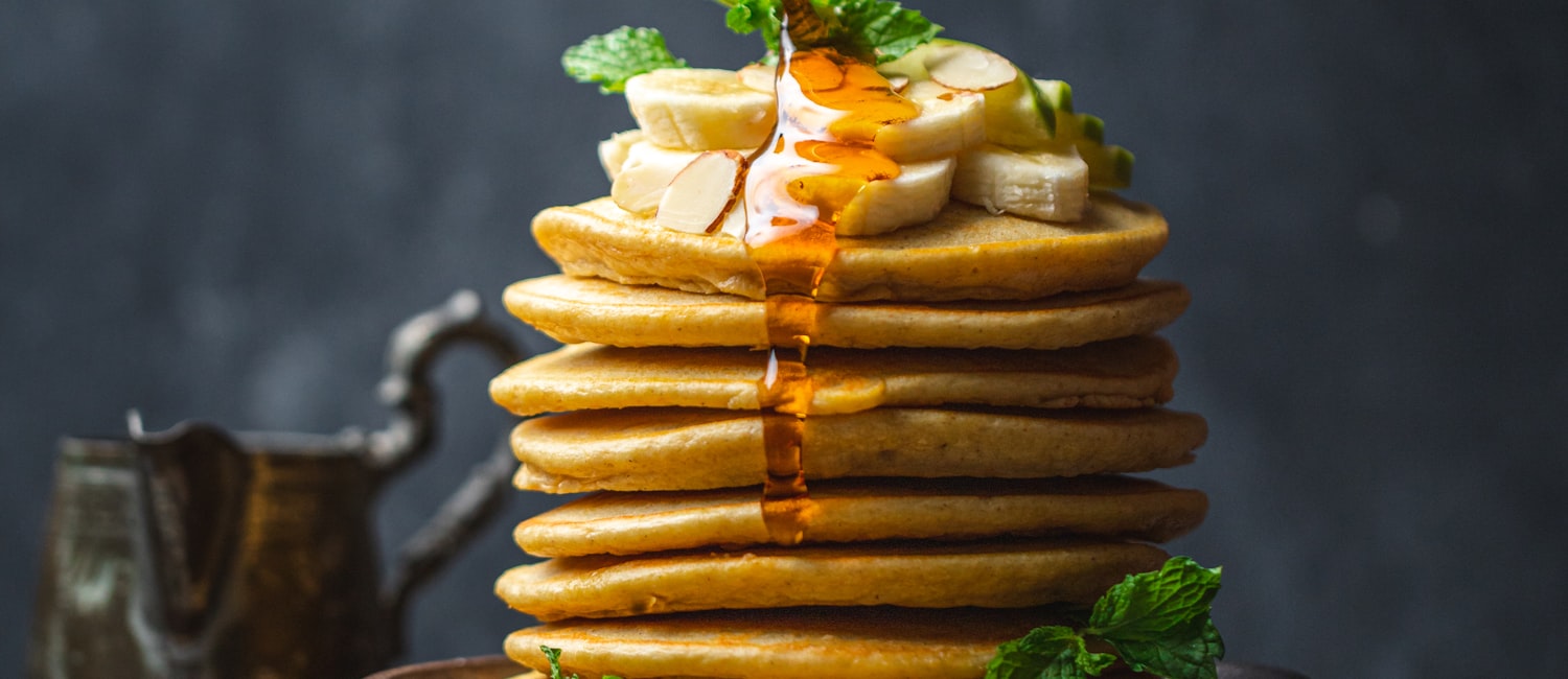 Pancakes with syrup and fresh fruit, part of the free hot breakfast